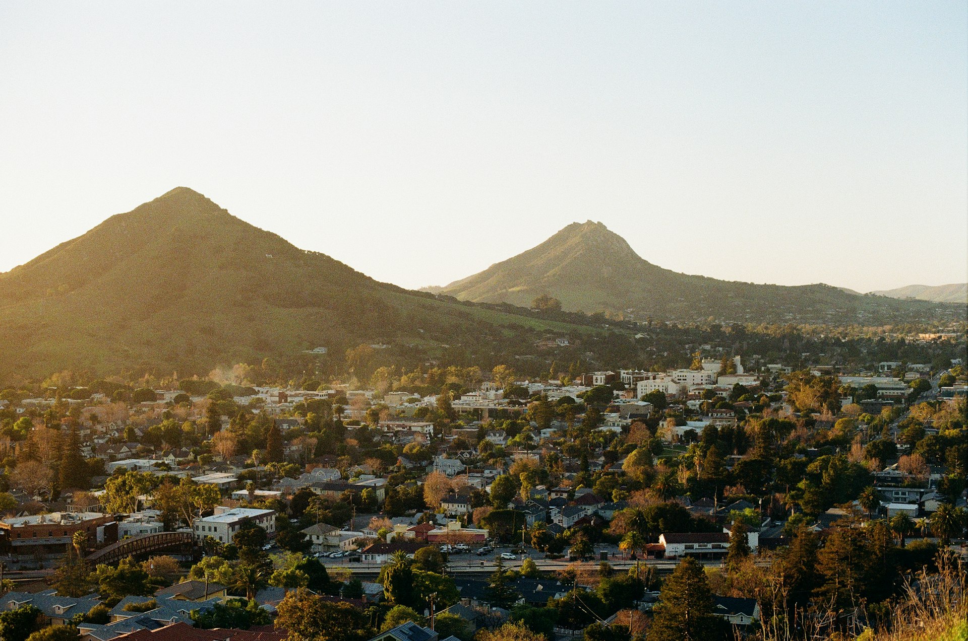 San Luis Obispo at golden hour, with Bishop Peak and Cerro San Luis rising behind the city
